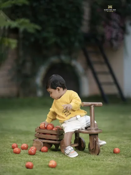 This little helper is busy gathering tomatoes in our garden. We love creating playful and interactive themes for our photoshoots.