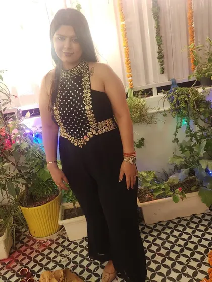 A client looking confident and happy in her custom black jumpsuit. The perfect outfit for a night of festivities.