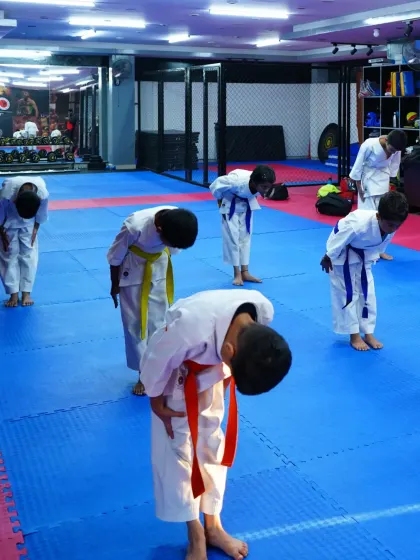 Young students in their karate gi bow to show respect, a fundamental practice at the beginning and end of every class.