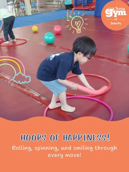 Hoops of happiness! We use simple props like hula hoops and balls in creative ways to develop motor skills and keep the energy high.