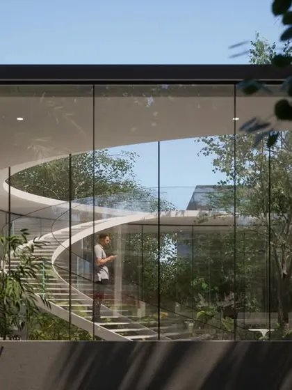 The curved staircase of the Vastu residence, seen through the expansive glass walls. The design emphasizes natural light and a constant visual connection to the outdoors, adhering to Vastu principles while maintaining a modern aesthetic.