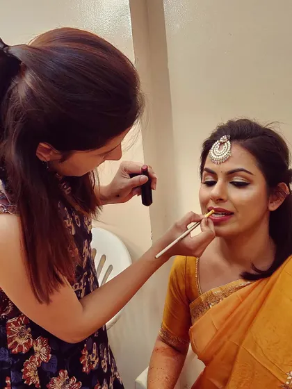 Precision is key, especially when defining the lips. Here I am applying lipstick with a brush to ensure a clean, sharp, and long-lasting finish for my client's special day.