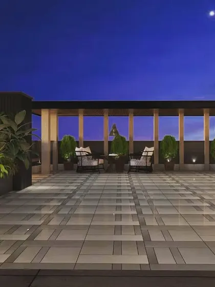 Another angle from our 3D design portfolio, showcasing a spacious terrace with multiple seating areas and planters, all under a clear night sky.