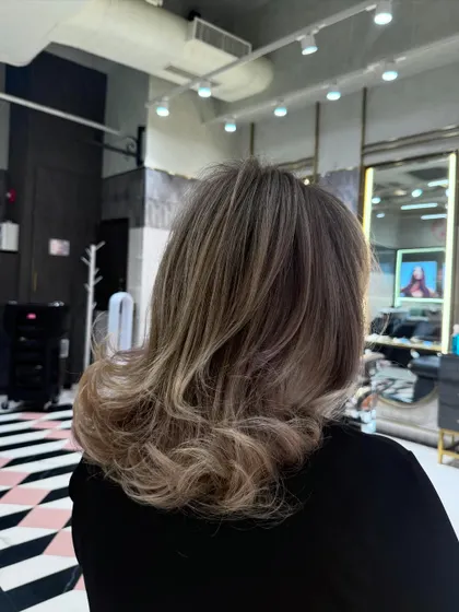 A look at the finished balayage from the back, showing the seamless transition of color and the healthy shine of the hair after styling.