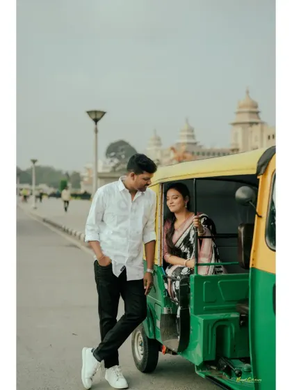 A unique and charming pre-wedding shoot concept featuring a classic Bangalore auto-rickshaw. The bride sits inside while the groom leans casually, creating a cool, urban vibe.