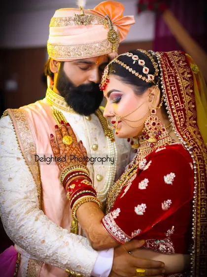 An intimate portrait of the bride and groom. The rich colors of their wedding outfits and the tender embrace make this a classic and romantic shot.