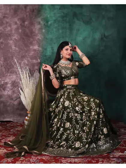 Elegance captured in a single frame. This portrait showcases a stunning traditional lehenga, where we used a painterly backdrop and soft lighting to highlight the intricate details of the fabric and jewelry.
