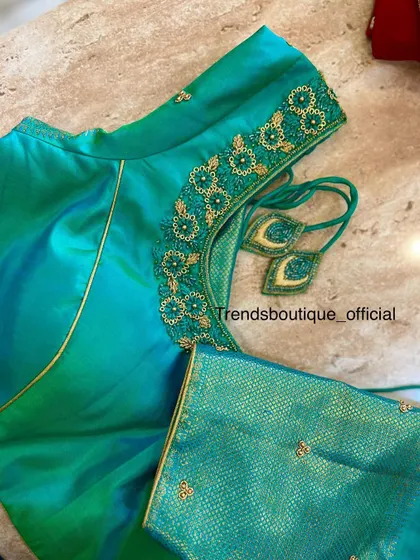 A duplicate image of the teal green blouse.
