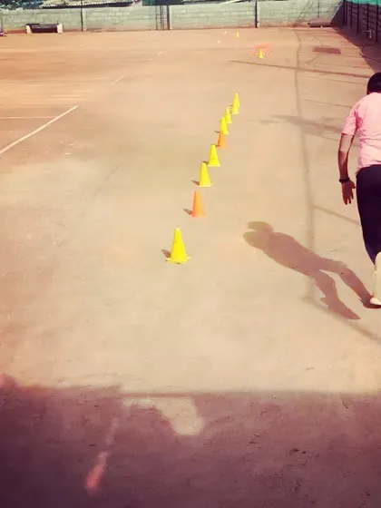 Players complete a cone drill designed to improve their forward and backward movement on the court.