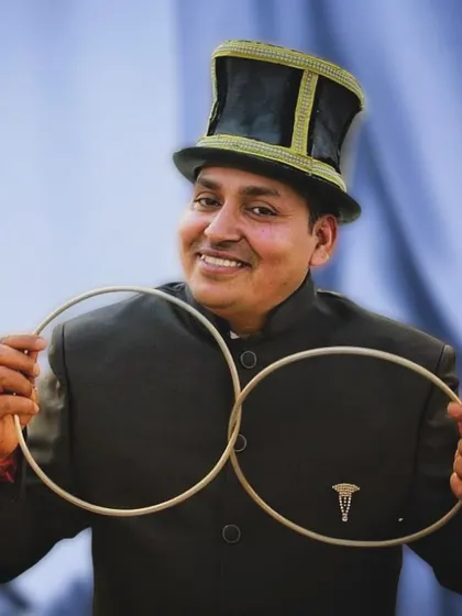 A classic magician's portrait with the linking rings. This timeless trick is a symbol of connection and mystery, which are at the heart of my magic.