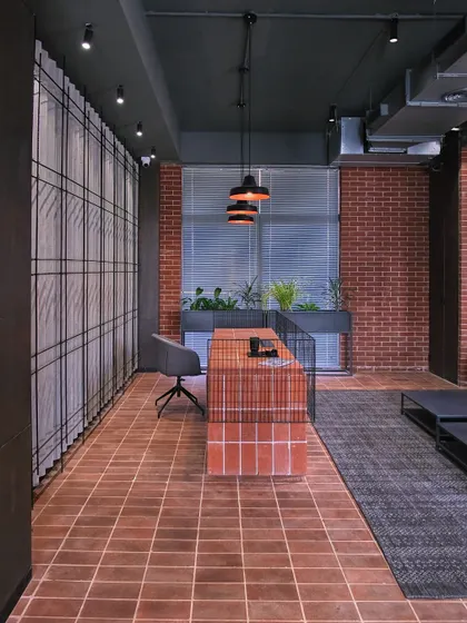 The reception at the Jaipuria Institute of Management student housing in Noida. We used a palette of raw, honest materials like exposed brick, terracotta tiles, and mild steel to create a warm, grounded, and welcoming first impression.