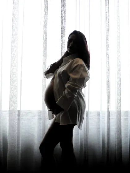 A simple and elegant silhouette maternity portrait. Using just a white shirt and natural light from a window, we can create dramatic and timeless images that celebrate the female form.