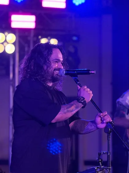 A candid shot of our frontman smiling while performing. We genuinely have a blast at every show, and that joy is infectious.