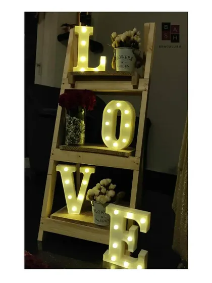 This decorative ladder shelf is a unique way we display marquee letters and floral arrangements. It adds height and visual interest to a room corner, turning it into a charming and personalized decor piece for a date night.