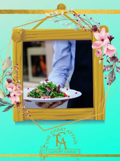 A server presents a plate of our Palak Patta Chaat. This fusion dish features crispy spinach leaves topped with yogurt, chutneys, and spices, offering a unique and delicious twist on traditional chaat.