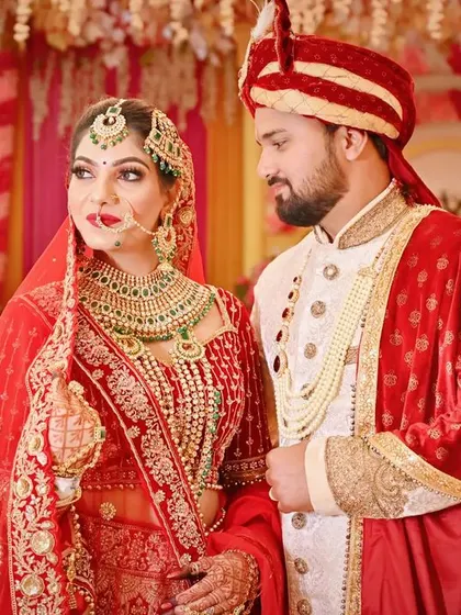 A classic wedding portrait where the groom admires his bride, capturing a quiet moment of love amidst the celebrations.
