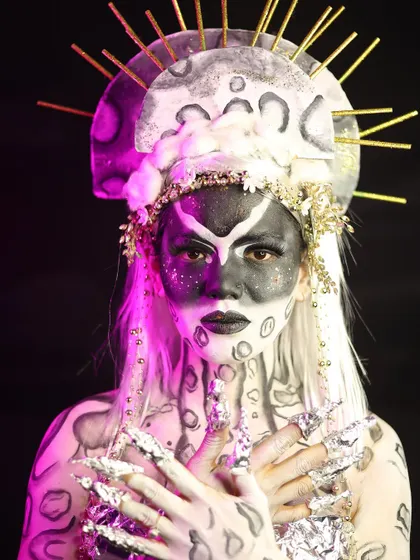The full look, complete with an elaborate headpiece, showcasing the student's creativity in costume and makeup.