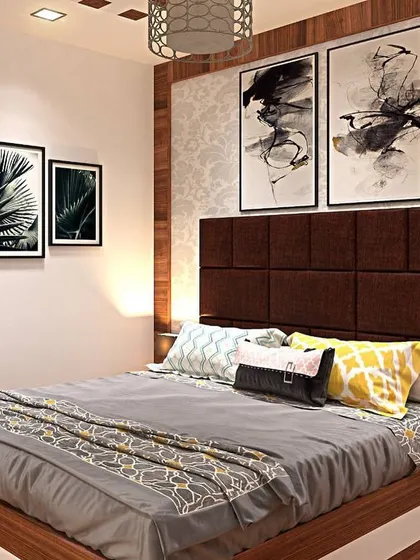This bedroom showcases a rich brown tufted headboard and complementary wooden furniture. The abstract art and patterned wallpaper add layers of texture and visual interest.