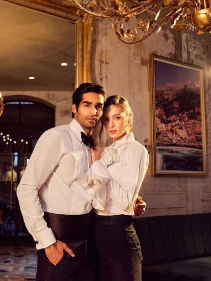 A sophisticated couple shot for Camessi Collections. The warm, ambient lighting of the luxurious location complements the classic elegance of the formal wear.