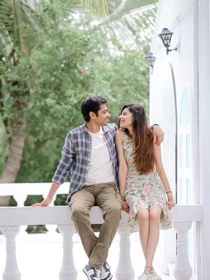A relaxed portrait of the couple sitting together. This image showcases a natural interaction, perfect for telling their love story in a casual, authentic way.