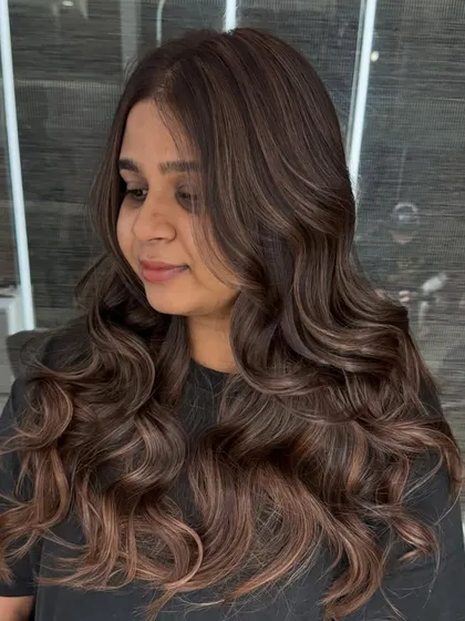 Another angle of the chestnut brown balayage, showing how the color catches the light. The soft waves highlight the different dimensions within the hair color.