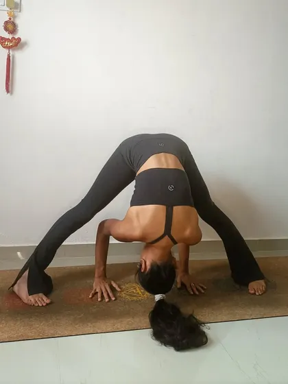 A wide-legged forward fold, or Prasarita Padottanasana. This pose is a wonderful way to stretch the hamstrings and release tension in the lower back.