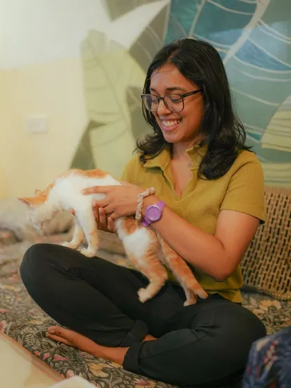 A participant takes a break from painting to cuddle with one of our friendly kittens. These interactions are what make our fundraising events so special.