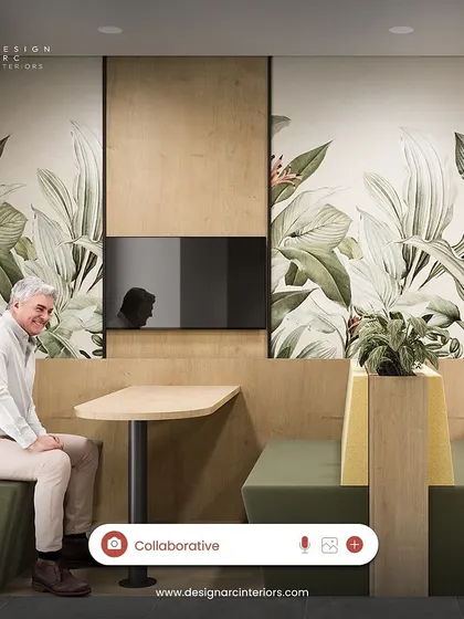 A cozy booth seating arrangement within a larger collaborative zone. The wood paneling and botanical wallpaper create a sense of privacy and connection to nature, ideal for small group discussions.