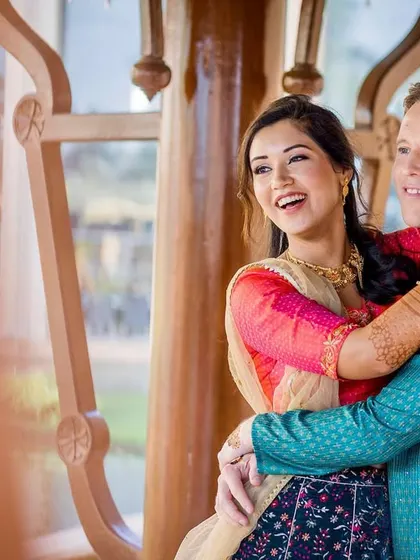 A joyful, candid moment. The couple is laughing and embracing, their happiness is infectious and makes for a beautiful, natural portrait.