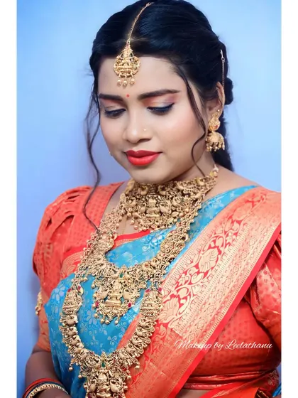 A close-up from a bridal portfolio shoot. This highlights the precision of the eye makeup, the contouring, and the rich color of the lipstick.