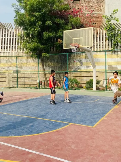 A junior player practices dribbling down the court in an open space.