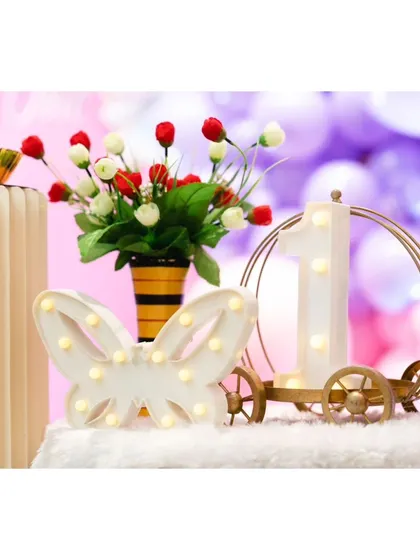 A detail shot of the light-up number '1' and butterfly prop.