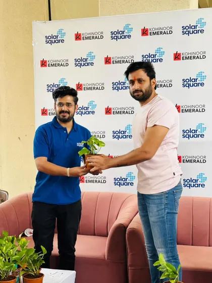Our team member presents a sapling to a resident of Kohinoor Emerald, marking a new green beginning for the society.