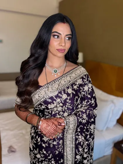 A three-quarter view of this stunning saree look. The makeup is soft and glamorous, perfect for any formal event.