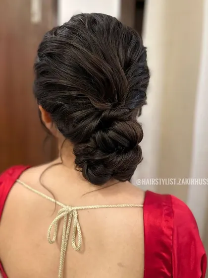 A slightly different angle of the unadorned textured bun, highlighting the interwoven sections. This style is ideal for bridesmaids or for a pre-wedding event.