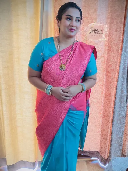 A full-length view of this guest's traditional look. The pink and blue saree combination is vibrant, and the makeup is designed to complement it perfectly.