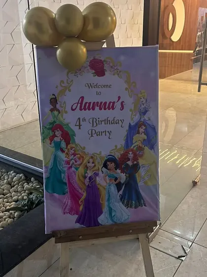 A personalized welcome board is a great way to greet guests. This one was created for Aarna's 4th birthday party, featuring all the popular Disney Princesses.