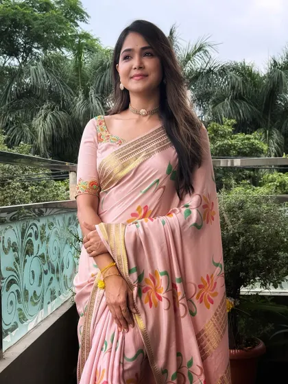 The soft pastel pink and floral design make this a perfect outfit for daytime festivities.