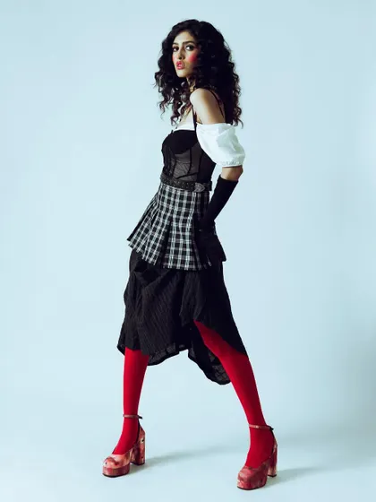 A side profile of the doll-like character, showcasing the complete silhouette against a clean background. This is ideal for a designer lookbook.