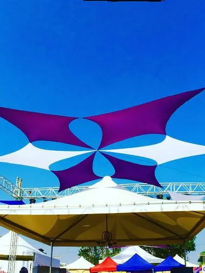 This is how I transform an open field into a vibrant festival space. This custom fabric canopy installation in Pune provided both shade and a stunning visual centerpiece for the Times Now food festival, using a dynamic pattern of purple and white sails against the sky.