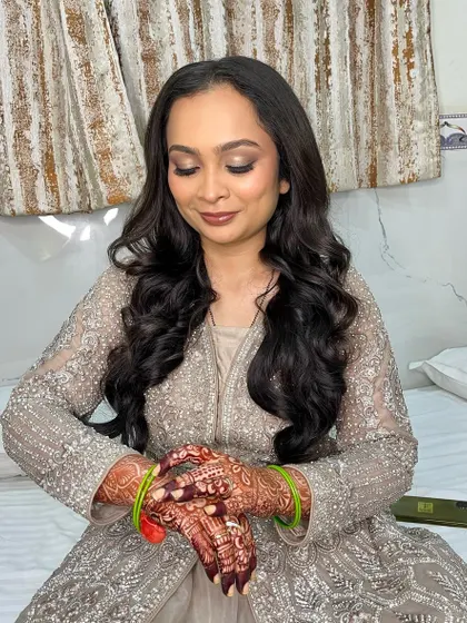 The bride looks elegant and poised in her reception outfit.