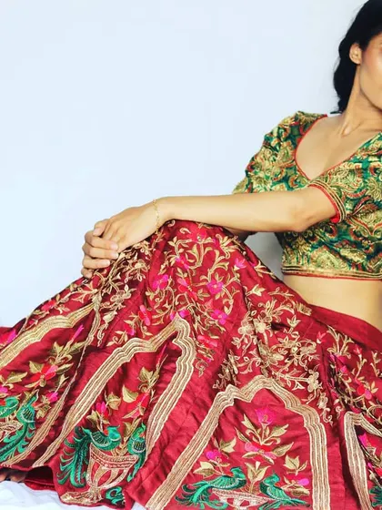 This traditional lehenga blends Banarasi and Mughal influences for a royal wedding look. The rich fabrics and intricate embroidery are perfect for a bride who wants a timeless yet unique ensemble.