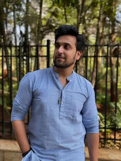 A simple and elegant portrait in a light blue cotton kurta. This demonstrates a more casual, everyday ethnic look suitable for a wide range of brands.