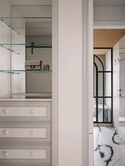 A glimpse into the master closet and bathroom, showing the seamless flow and the calm, organized design of the private spaces.