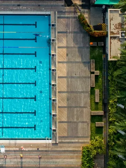 An aerial perspective of our 50m pool and the surrounding deck area, showing our well-maintained and organized facility.