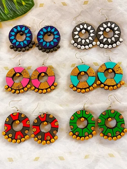 These 'chandbali' style hoop earrings feature geometric patterns and ghungroo-like terracotta beads. They are a modern take on a traditional shape.