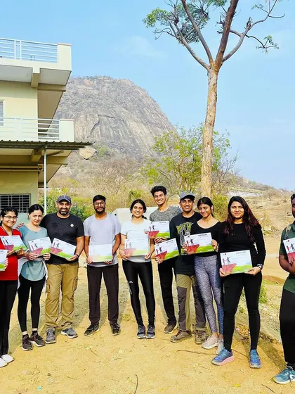The team at Kabaldurga with their certificates, standing in front of the mountain they just conquered. A perfect end to a challenging morning.