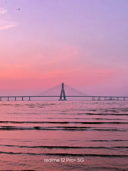 This 2x zoom shot of the Sea Link, taken on a mobile phone, provides a classic landscape view, balancing the bridge with the expansive sea and sky.