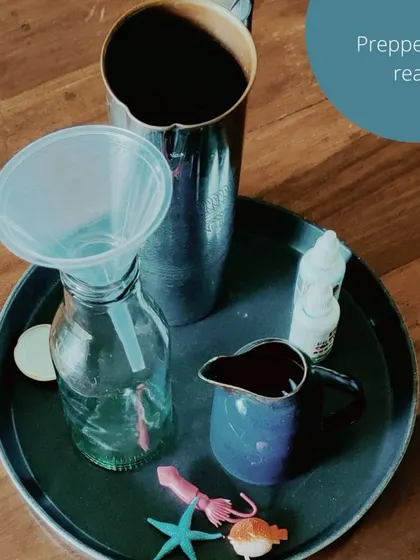 A closer look at our "Ocean in a Bottle" STEAM project. The activity involves precise actions like pouring and funneling, which helps develop fine motor skills while teaching basic scientific concepts in a hands-on way.