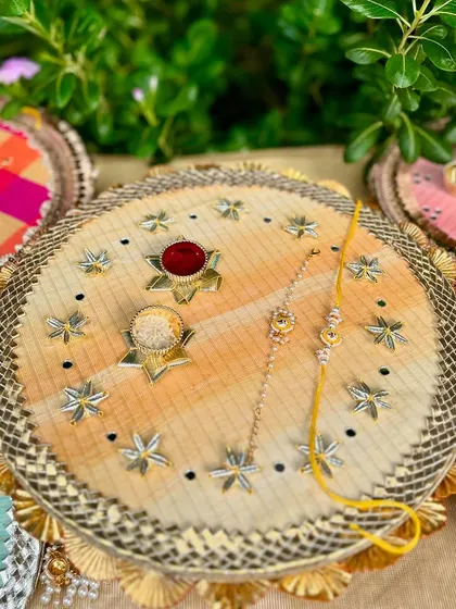 A closer look at the star-embellished Rakhi thal, highlighting the intricate details.